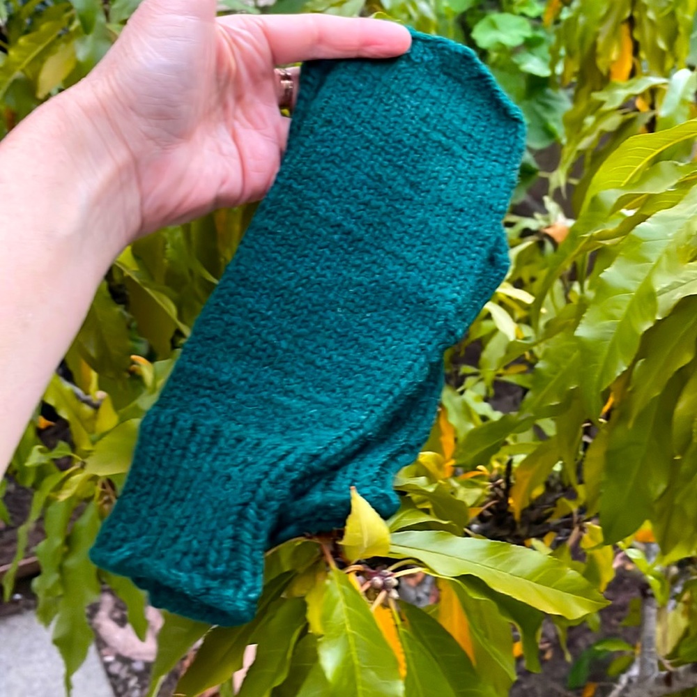 Dark green hand knitted wool mittens